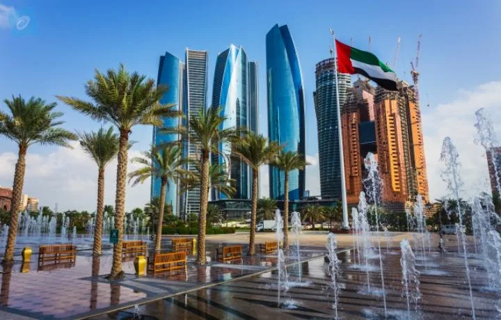Etihad Towers rising above the fountains and palm-lined plaza in Abu Dhabi