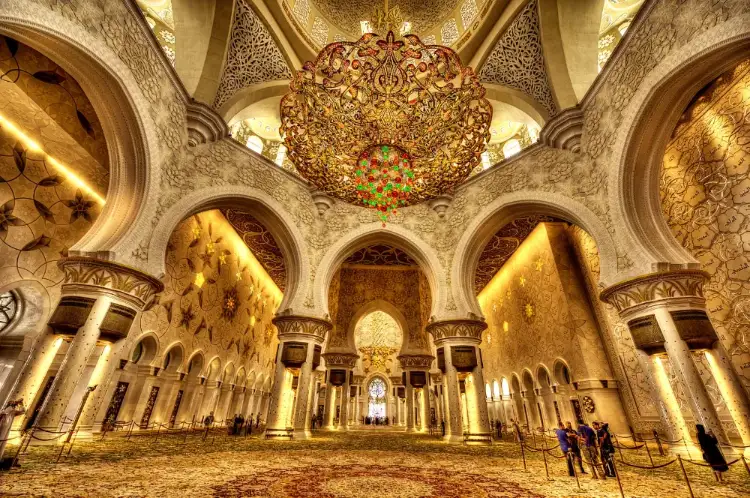 Gold chandelier and arched colonnades inside the Sheikh Zayed Grand Mosque prayer hall