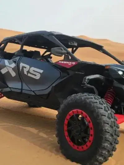 Can-Am dune buggy parked on the red dunes outside Dubai