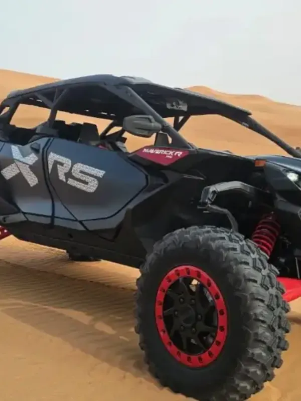 Can-Am dune buggy parked on the red dunes outside Dubai