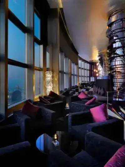 Burj Khalifa At The Top observation lounge overlooking the Dubai skyline at dusk