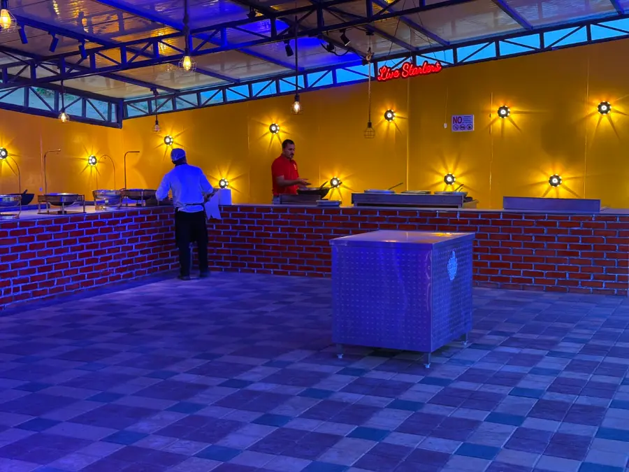 Air-conditioned majlis lounge at the VIP desert safari camp lit at dusk in Dubai