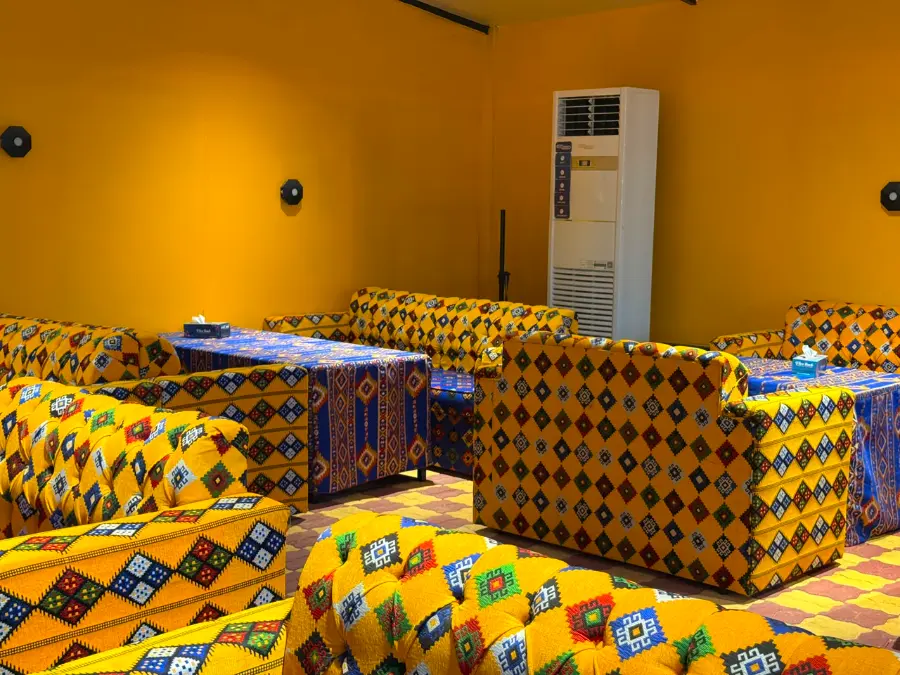 Patterned majlis sofa seating with low tables inside the air-conditioned VIP lounge